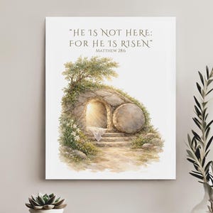 May include: Watercolor print of an open tomb with the text "HE IS NOT HERE: FOR HE IS RISEN" from Matthew 28:6. The artwork depicts a stone tomb with a large round stone, a bright light emanating from within, and a small tree.
