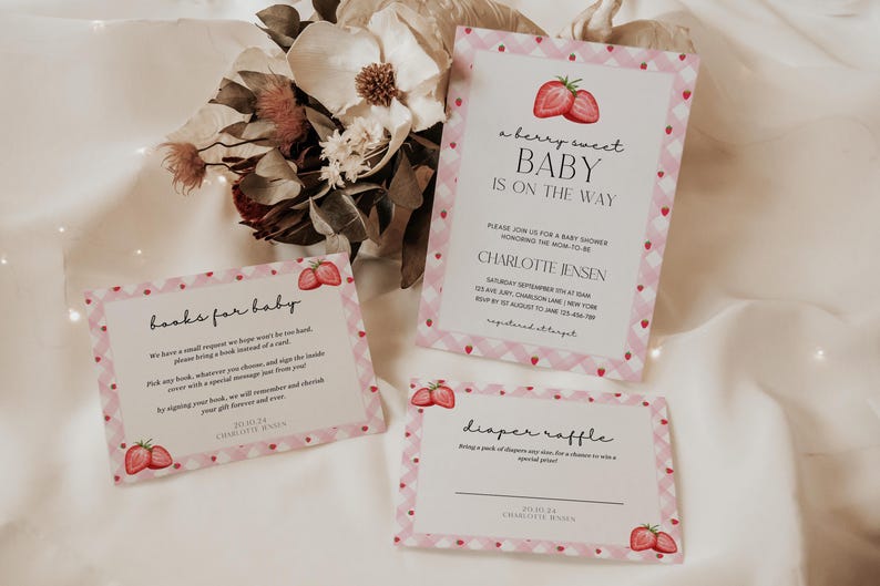 May include: Pink and white baby shower invitation with a strawberry design. The invitation says "a berry sweet baby is on the way" and includes the name Charlotte Jensen. There are also cards for a diaper raffle and a book request for the baby.