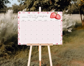 Puede incluir: Un calendario rosa y blanco para baby shower sobre un caballete de madera. El calendario tiene un tema de fresas con el texto "Adivina la llegada del bebé Jensen". El calendario está decorado con ilustraciones de fresas.