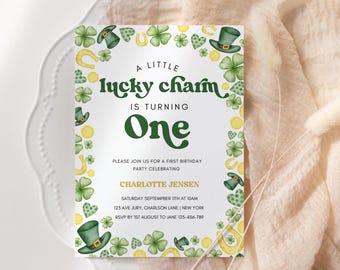 May include: A white invitation with green shamrocks, gold horseshoes, and green leprechaun hats. The text reads "A Little Lucky Charm is Turning One. Please join us for a first birthday party celebrating Charlotte Jensen. Saturday September 11th at 10am. 125 Ave Jury, Charleston Lane | New York. RSVP by 1st August to Jane 123-456-789."