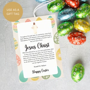 May include: A colourful Easter gift tag with a pastel green, yellow, and pink background. The tag features a white silhouette of Jesus Christ with the text "Jesus Christ" in bold, black letters. The text continues with a quote from Russell M. Nelson about the importance of faith in Jesus Christ. The tag is decorated with colourful Easter eggs and the text "Happy Easter" in a decorative font.