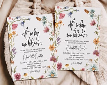 May include: Two floral baby shower invitations with a white background and a wreath of watercolor flowers. The text reads "Baby in Bloom" and includes the date, time, and location of the event. The invitations are for Charlotte Carter.