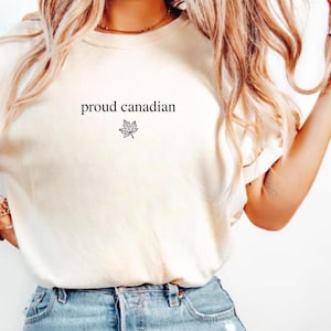 May include: A white t-shirt with the text "proud canadian" and a maple leaf graphic.