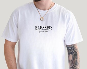 May include: White t-shirt with the text "Blessed to be called Dad" and "Proverbs 20:7" printed on the front.