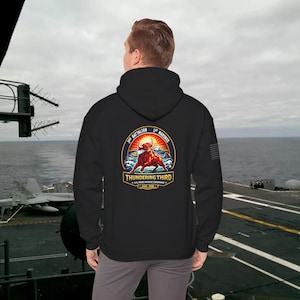 May include: Black hoodie featuring a colorful graphic of a bull, sun, and waves, with the text "Thundering Third" and "3rd Battalion 1st Marines". The hoodie also has a small American flag patch on the sleeve.