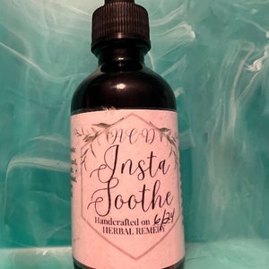 May include: A dark brown glass bottle with a dropper top and a white label that says "AED Insta Soothe Handcrafted on 6/24 HERBAL REMEDY".