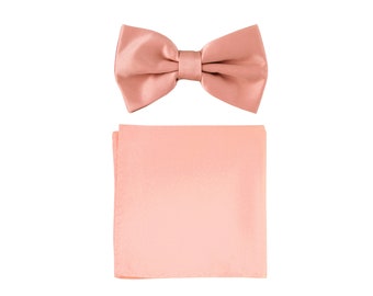 May include: A peach-colored bow tie and matching pocket square. The bow tie is made of satin and has a classic shape. The pocket square is also made of satin and is folded into a simple square shape.