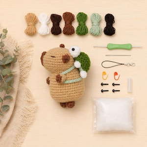 May include: A crochet kit with a light brown capybara and a green turtle. The kit includes various yarn colours, a crochet hook, safety eyes, stitch markers, and stuffing. Ideal for making amigurumi toys.