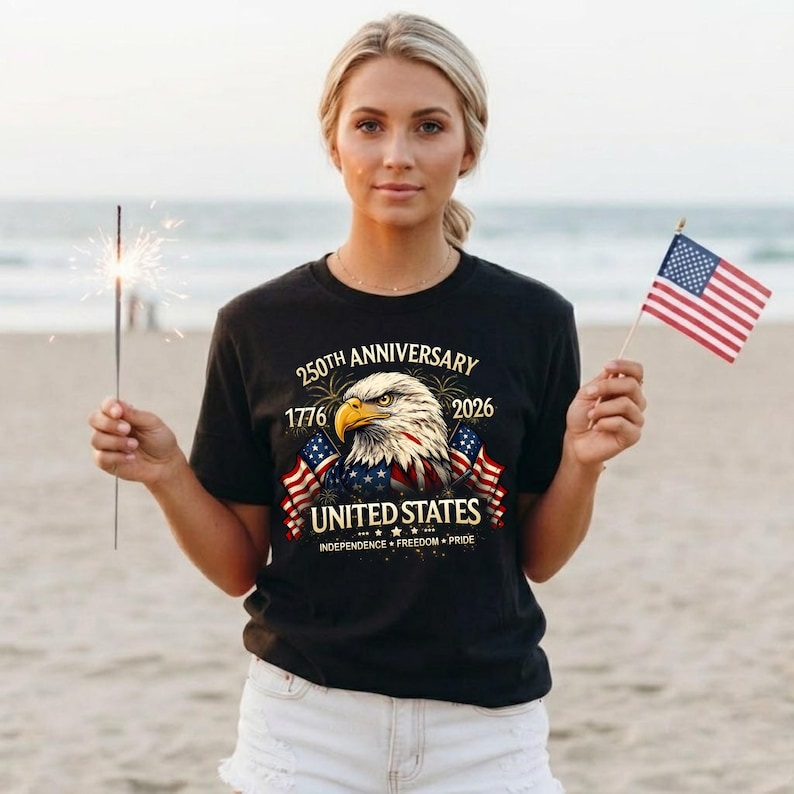May include: Black t-shirt with a patriotic design celebrating the 250th anniversary of the United States. The graphic features an eagle, American flags, and the text "United States: Independence, Freedom, Pride."