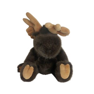 May include: A plush moose toy with brown fur and tan antlers, feet, and inner ears. The stuffed animal is sitting upright with its legs extended. The moose has a soft, furry texture and is designed to look like a realistic moose.