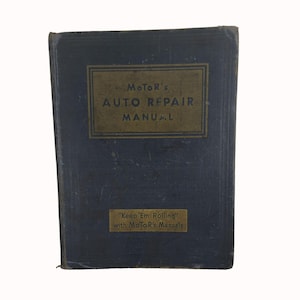 May include: A blue hardcover book titled "Motor's Auto Repair Manual" with gold lettering. The book has a gold sticker on the bottom that reads "Keep 'Em Rolling' with Motor's Manuals".