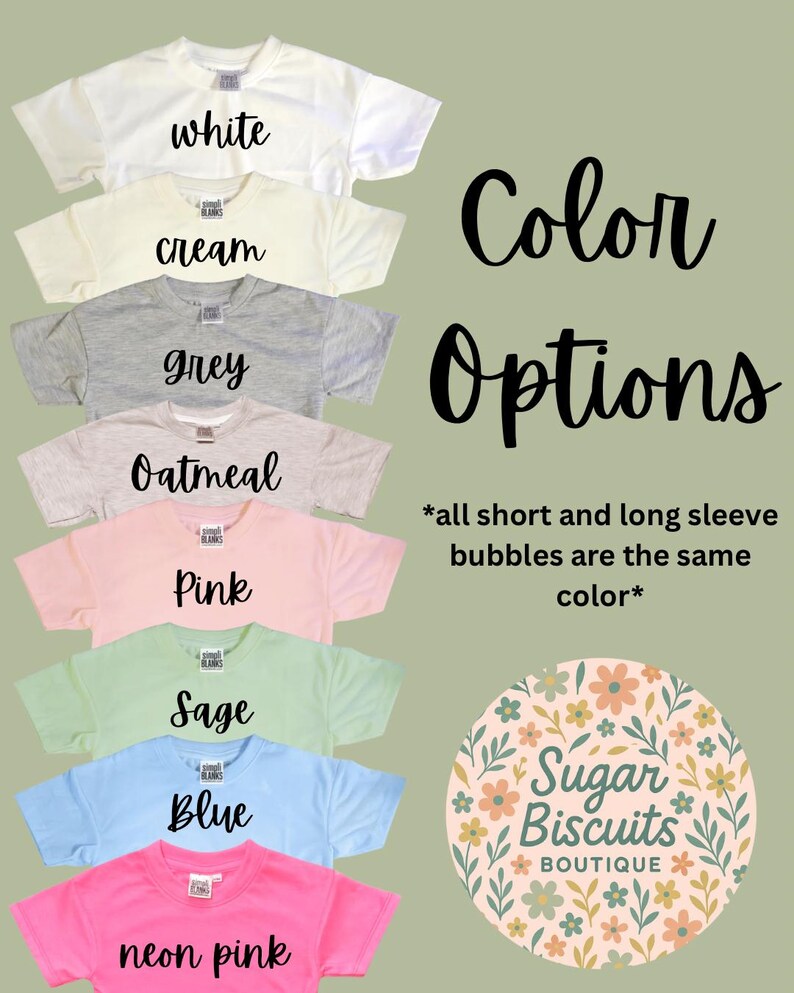 May include: A selection of t-shirts in shades such as white, cream, grey, oatmeal, pink, sage, blue, and neon pink. Each shirt displays its colour name. The image also includes the words "Color Options" and the Sugar Biscuits Boutique logo.