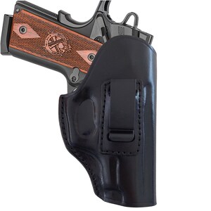 May include: A black leather holster with a clip for a handgun. The holster is designed to be worn on a belt.