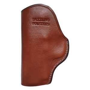 May include: A brown leather holster with a stitched edge and the text "DAZZLING HOLSTERS" embossed on the front.