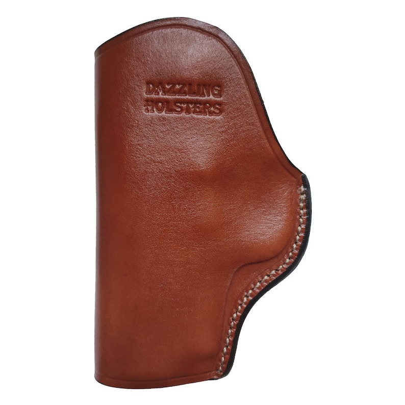 May include: A brown leather holster with a stitched edge and the text "DAZZLING HOLSTERS" embossed on the front.