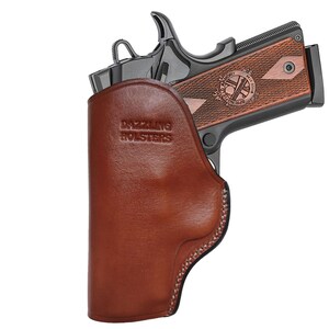 May include: A brown leather holster with the text "Dazzling Holsters" embossed on the front. A black handgun is partially visible inside the holster.