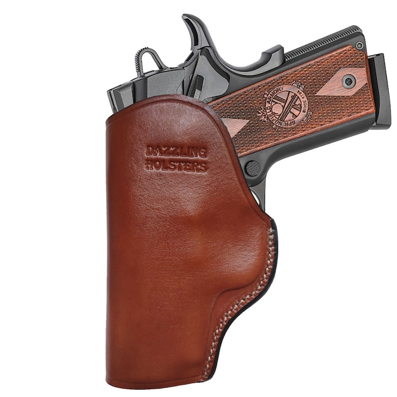 May include: A brown leather holster with the text "Dazzling Holsters" embossed on the front. A black handgun is partially visible inside the holster.