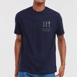 May include: A navy blue t-shirt with a graphic of gardening tools and the text "Head Gardener Grandad Jones".