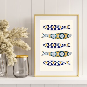 May include: A framed print with a white background and five blue and yellow fish with geometric patterns. The fish are arranged vertically in a row.