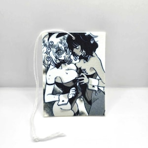 May include: Black and white illustration of two women in bunny costumes. One woman is holding the other woman's chest. The image is printed on a white card with a string attached.