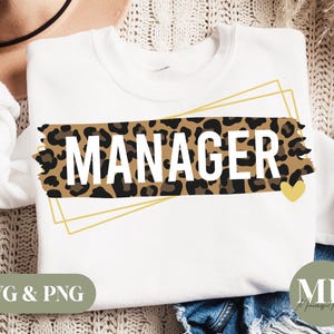 May include: White sweatshirt with a gold frame and a leopard print design that says "MANAGER" with a small gold heart.