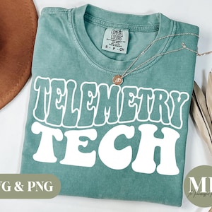 May include: A teal blue t-shirt with the words "Telemetry Tech" in white, retro-style lettering. The shirt is made of a soft, comfortable fabric and has a distressed look.