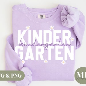 May include: A lavender sweatshirt with the text "Kinder* kindergarten* GARDEN" in white. The text is surrounded by small white daisies.