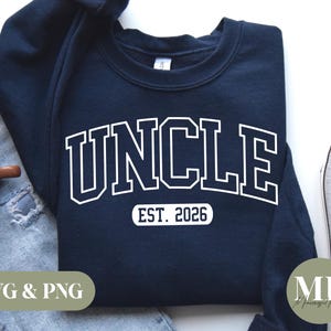 May include: A navy blue sweatshirt with white text that reads "UNCLE EST. 2026".