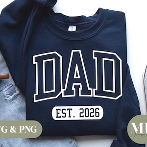 May include: A navy blue sweatshirt with the word "DAD" in white outlined letters and the text "EST. 2026" below it.
