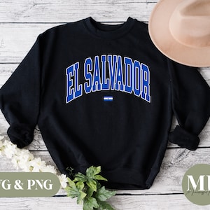 May include: Black sweatshirt with a blue and white graphic of the text "EL SALVADOR" and a small blue and white flag.