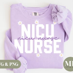 May include: Purple sweatshirt with the text "NICU nurse" in white letters and a daisy design. The text "nicu nurse" is in a smaller font and is below the larger text "NICU nurse".