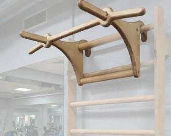 A wooden, sturdy dip bar with a removable pull-up bar attaches to a wall bar. Perfect for exercising at home or in a home gym.