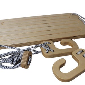 May include: A wooden swing set with a rectangular platform and two wooden hooks. The swing set is made of natural wood and has a rope with black and white accents.