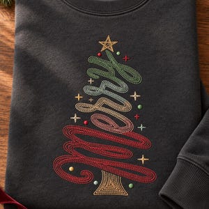 Könnte beinhalten: Ein anthrazitfarbenes Sweatshirt mit Rundhalsausschnitt und einer Stickerei, die einen Weihnachtsbaum in Form des Wortes Merry in Schreibschrift zeigt. Die Stickerei verwendet grünes, goldenes und rotes Garn mit kleinen Stern- und Punktmotiven.