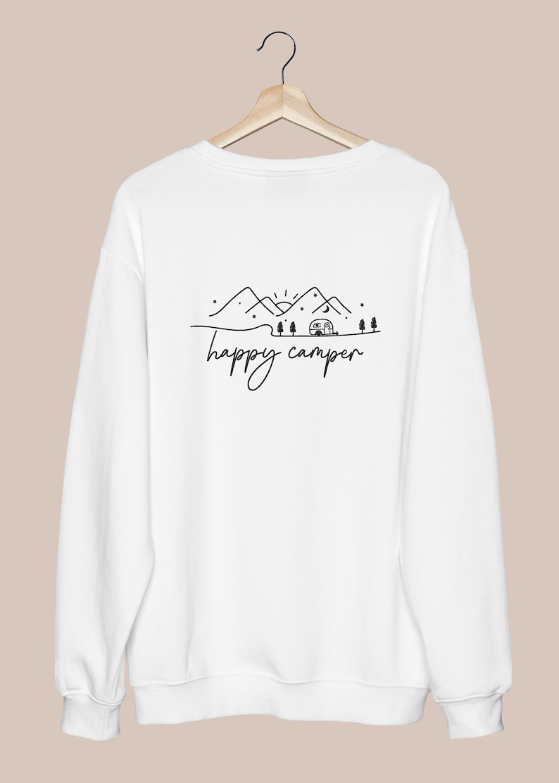 May include: White sweatshirt with a black graphic of mountains, a camper, and the text "happy camper".