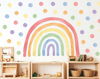 May include: A watercolour rainbow wall decal with pastel colours, featuring a rainbow arch with a purple, blue, green, yellow, and orange design. The rainbow is surrounded by colourful polka dots in various shades of pink, purple, yellow, and green.