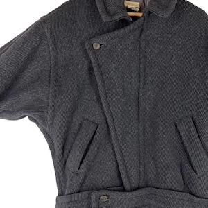 Puede incluir: Una taza de cer&aacute;mica blanca con un asa negra y el texto "But First, Coffee" en negro, con una fuente de estilo manuscrito. La taza est&aacute; sobre una superficie blanca.