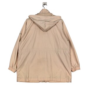 May include: A light beige hooded jacket with a zipper closure and a drawstring waist.