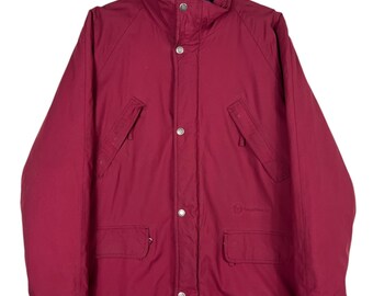 May include: A red, long-sleeved, button-up jacket with a black lining. The jacket has a high collar, two pockets on the front, and a drawstring at the bottom.