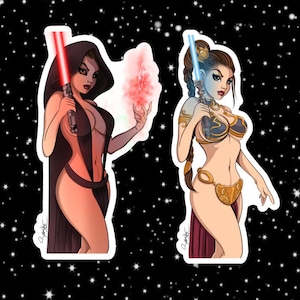 May include: Two illustrated female characters, one in a black and red outfit holding a red lightsaber, the other in a gold and blue outfit holding a blue lightsaber.