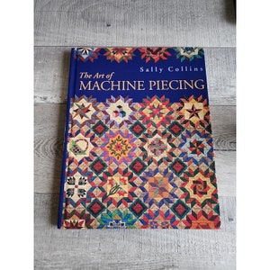 May include: The Art of Machine Piecing book by Sally Collins. The cover features a colorful quilt design with various geometric patterns and star shapes.