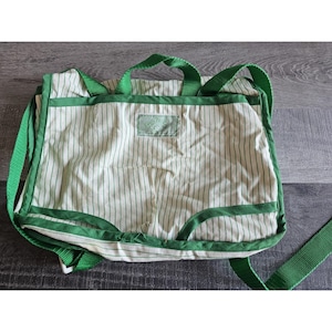 May include: A green and white striped canvas tote bag with green handles and a green label that says "L.L.Bean" in white lettering.