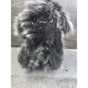 May include: A set of three ceramic mugs with a speckled, matte finish. The mugs are in shades of cream, light gray, and dark gray. Each mug has a simple, minimalist design, perfect for coffee or tea.