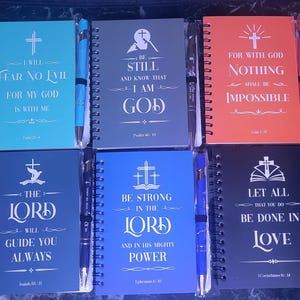 May include: Ten small, spiral bound notebooks with inspirational Christian quotes and matching pens. Each notebook has a different color cover and a different quote. The quotes include: "Don't worry about anything instead pray about everything", "I will fear no evil for my God is with me", "Be still and know that I am God", "For with God nothing shall be impossible", "May the God of hope fill you with all joy and peace", "I can do all things through Christ who strengthens me", "The Lord will guide you always", "Be strong in the Lord and in his mighty power", "Let all that you do be done in love", "Trust in the Lord with all your heart".