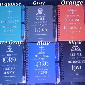 May include: Ten different colored spiral notebooks with inspirational quotes and a pen attached to each. The colors are brown, turquoise, gray, orange, plum purple, pink, slate gray, blue, black, and olive green.