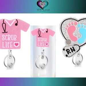 May include: Three pink and silver glitter badge reels with a stethoscope design. One reel features a pink scrub top with the text "Scrub Life" and a pink heart. Another reel features a pink scrub top with the text "Scrub Life" and a pink heart. The third reel features a silver heart with two pink and blue footprints and the text "RN".