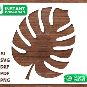 May include: A white cut-out design of a monstera leaf, set against a wood grain background. The image includes the text "INSTANT DOWNLOAD" and file type options: AI, SVG, DXF, PDF, and PNG. The Aadarch AdCraft logo is in the bottom right.