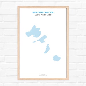 May include: A framed print with the text "Midwinter Madison" and "Just 5 Frozen Lakes". The print features a light blue outline of a lake with five islands.