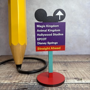 A wooden desk stand with an image of a Road Sign.