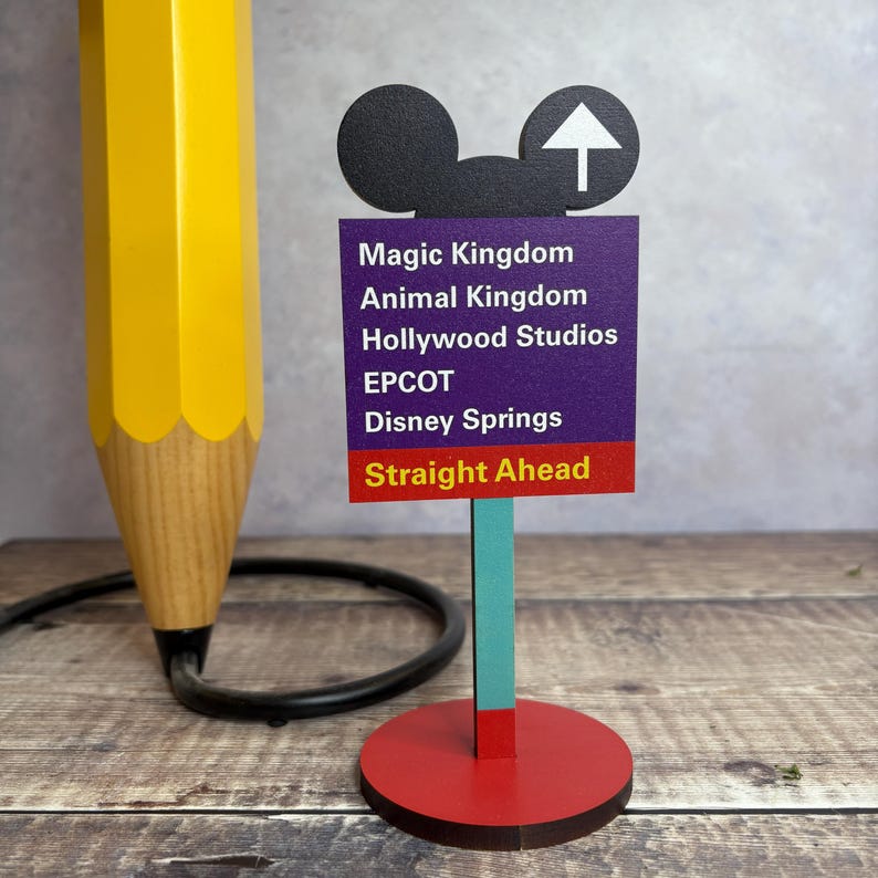 A wooden desk stand with an image of a Road Sign.